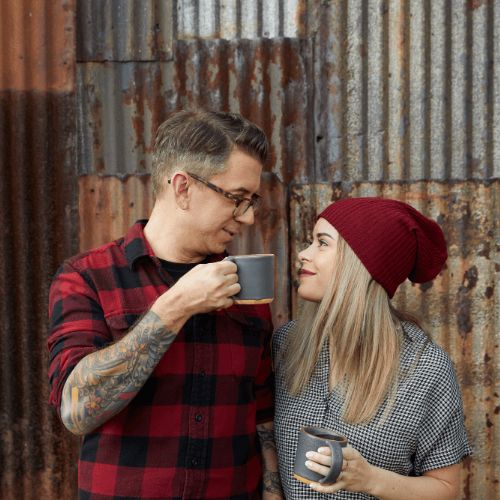 couple drinking coffee from gray mugs