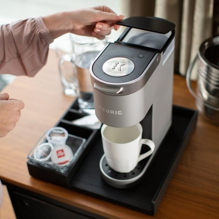 woman making coffee with a keurig mini brewer